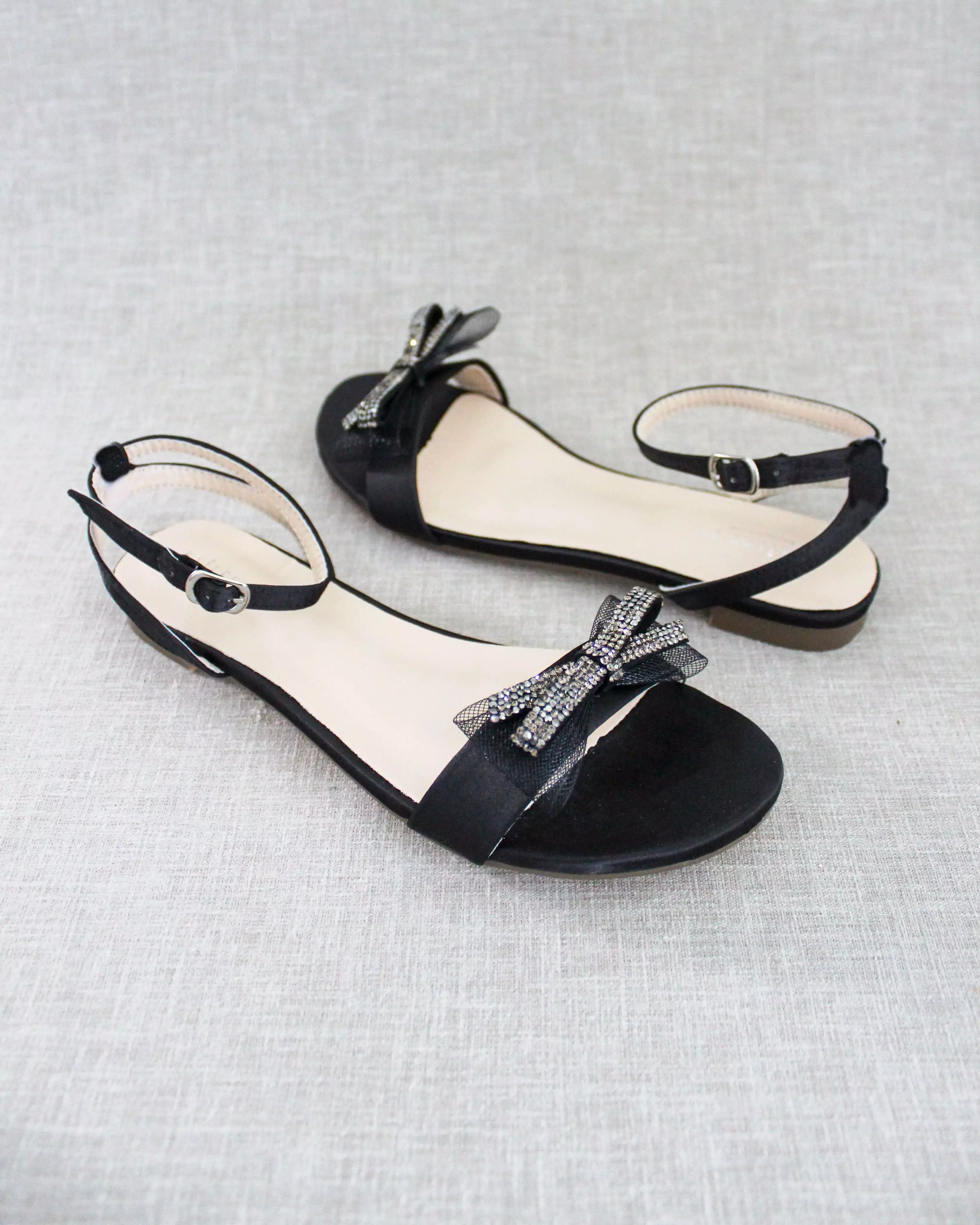 Black Satin Flat Sandal with Sparkling Rhinestone Bow and Ankle Strap