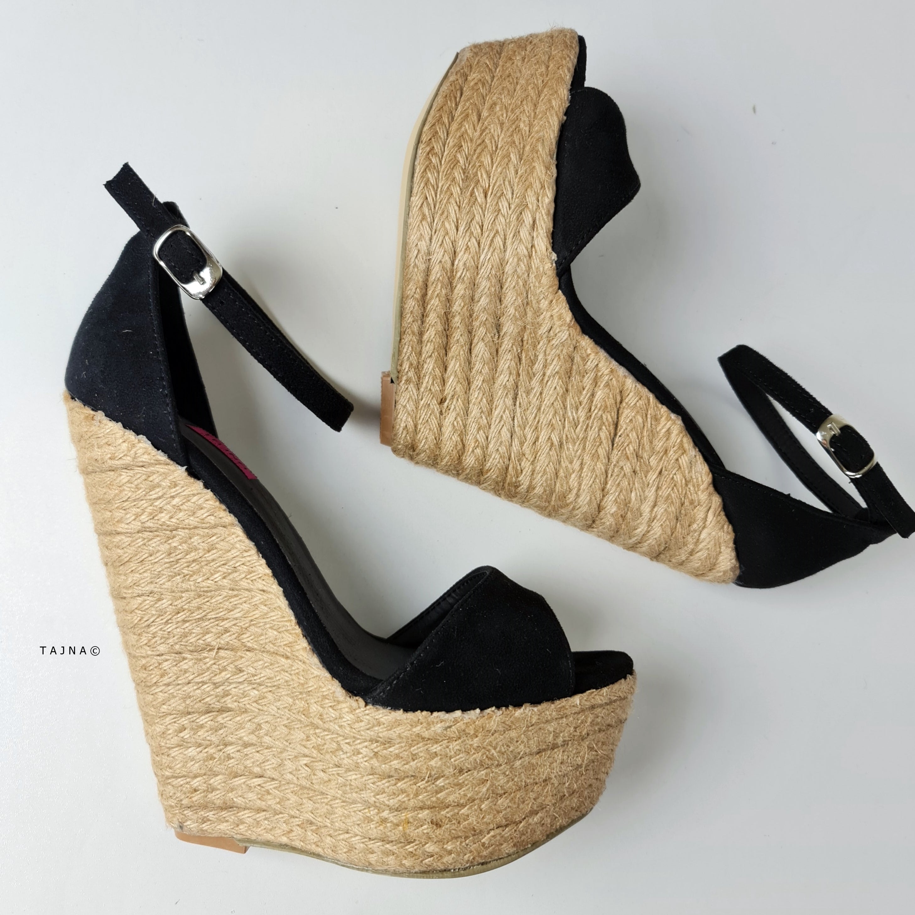 Black suede wedge sandals with ankle strap.