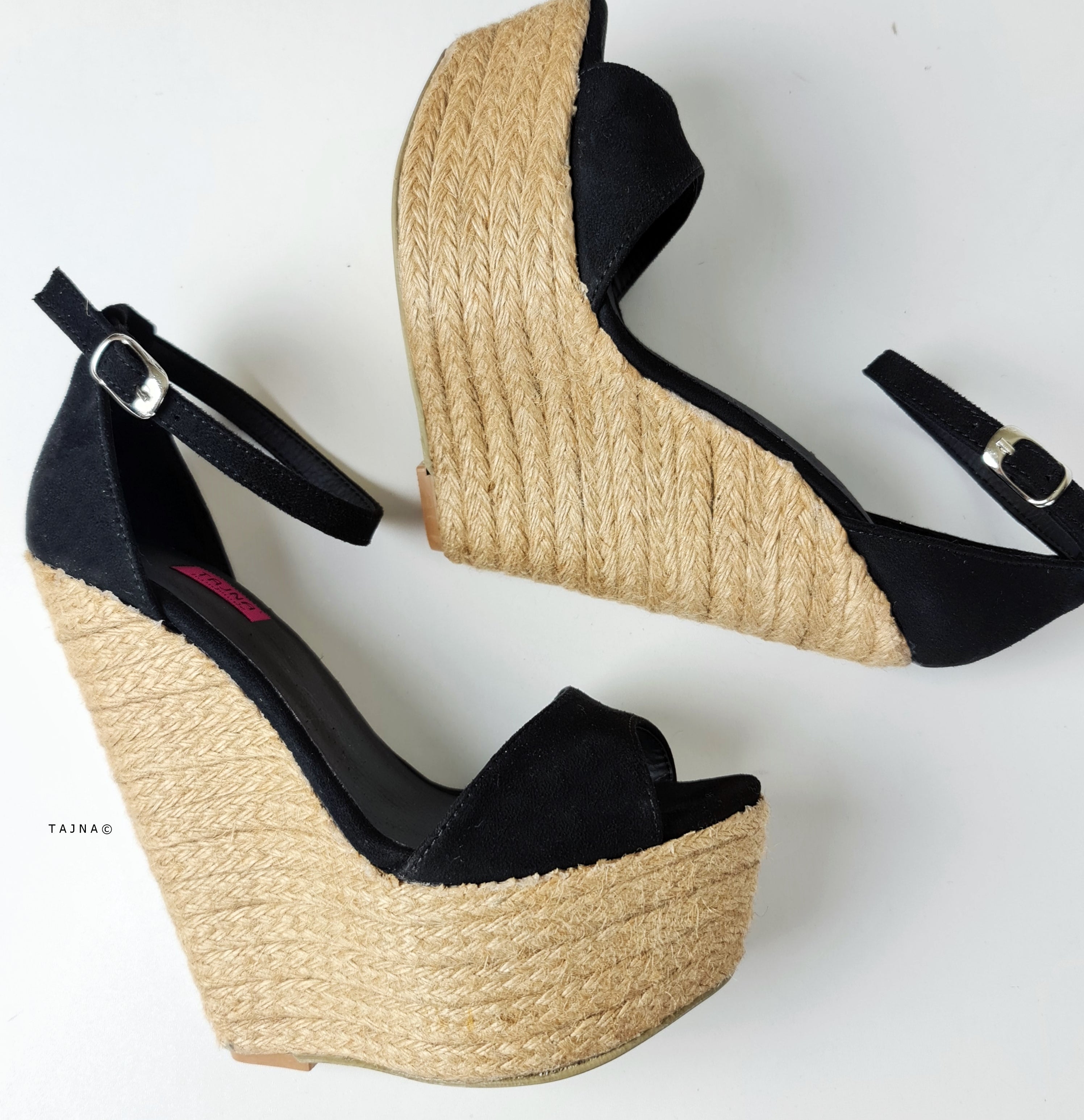 Black suede wedge sandals with ankle strap.