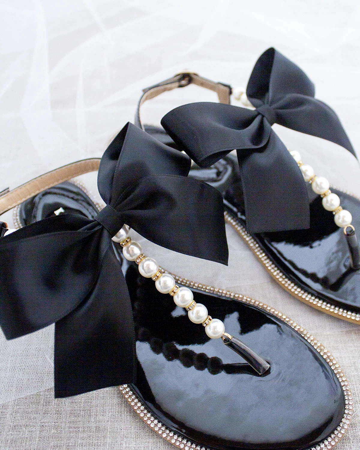 Black T-Strap Pearl Sandals with Rhinestone Embellishments and Large Satin Bow