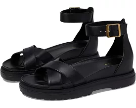 Cole Haan black leather ankle strap sandals with open rounded toe and chunky heel.