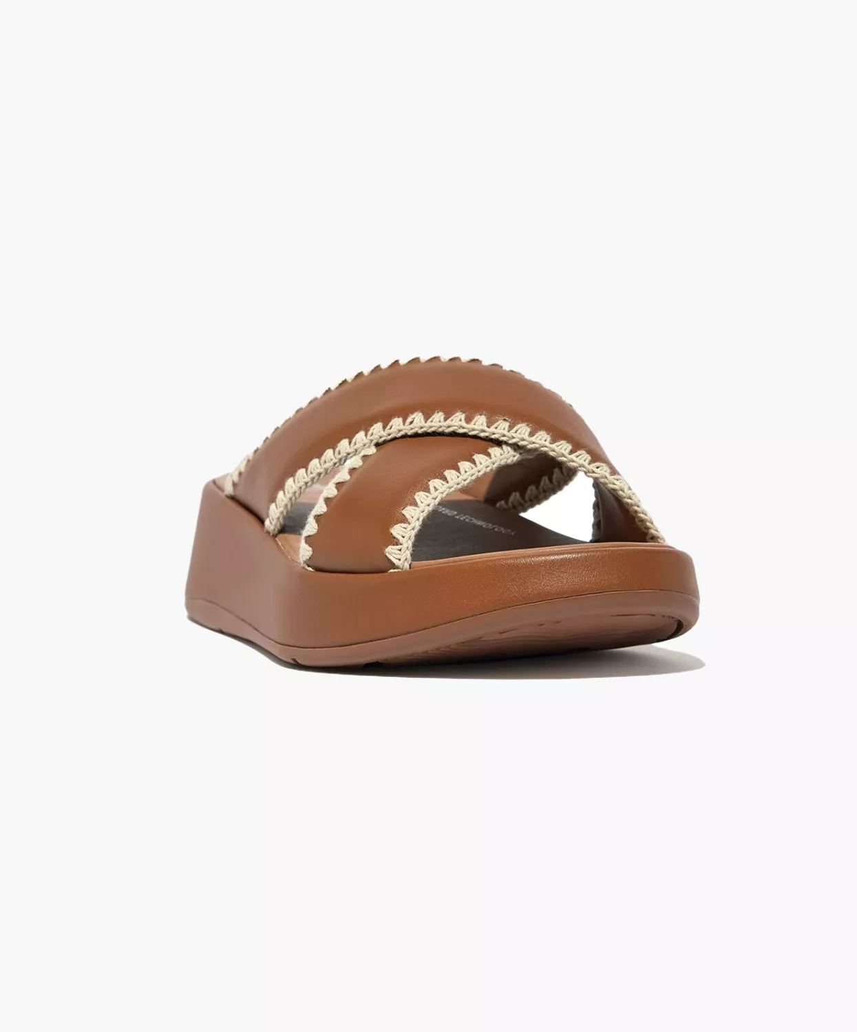 FitFlop crocheted leather flatform slides in tan.