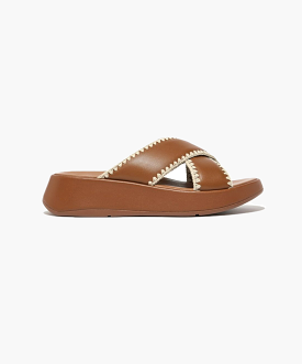 FitFlop crocheted leather flatform slides in tan.