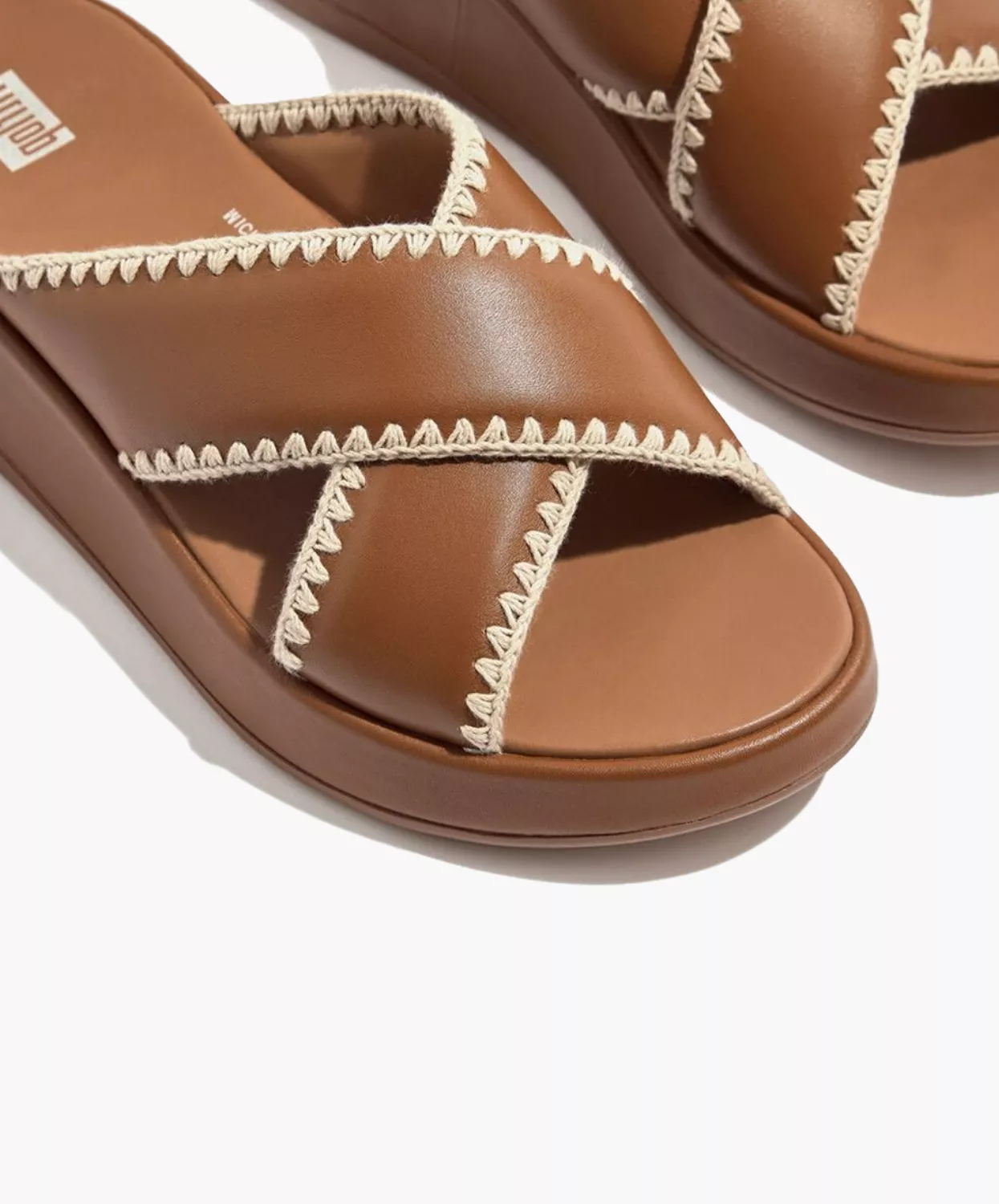 FitFlop crocheted leather flatform slides in tan.