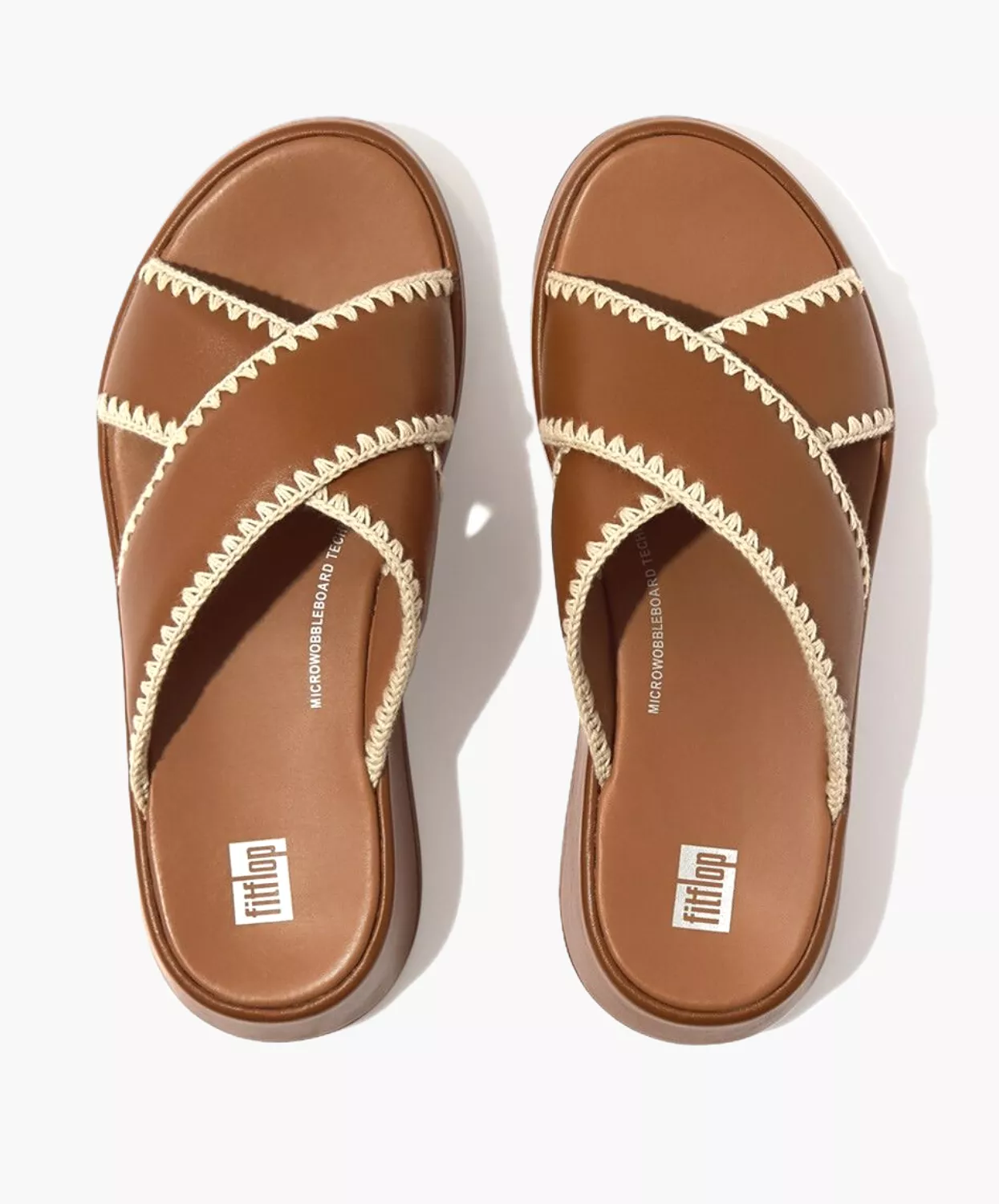 FitFlop crocheted leather flatform slides in tan.