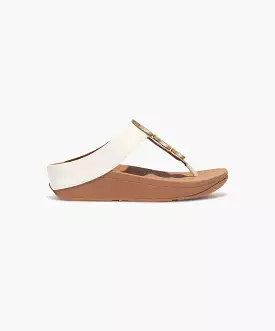 FitFlop sandals with metallic trim and toe post in cream color.