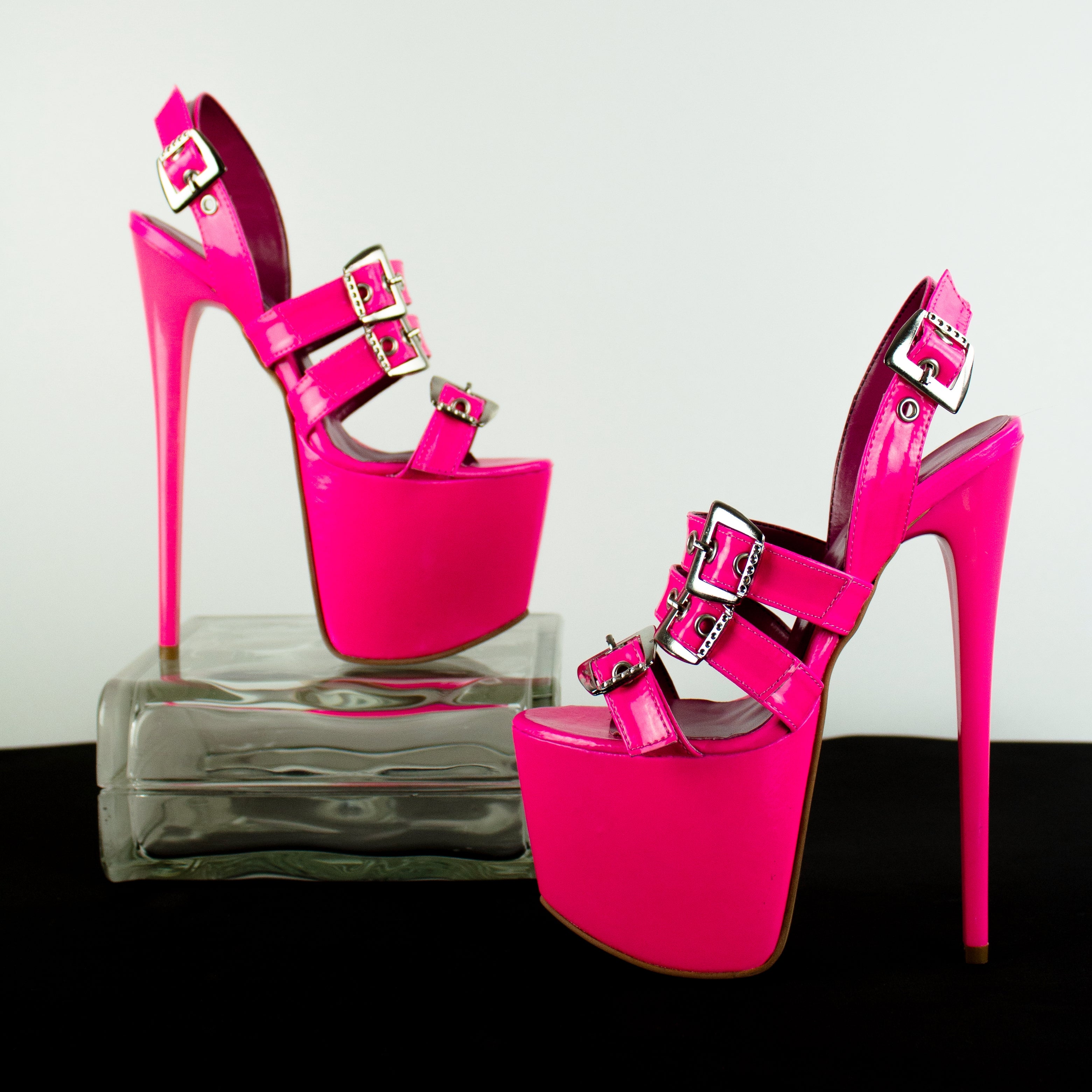 neon pink high heel sandals with multiple belts