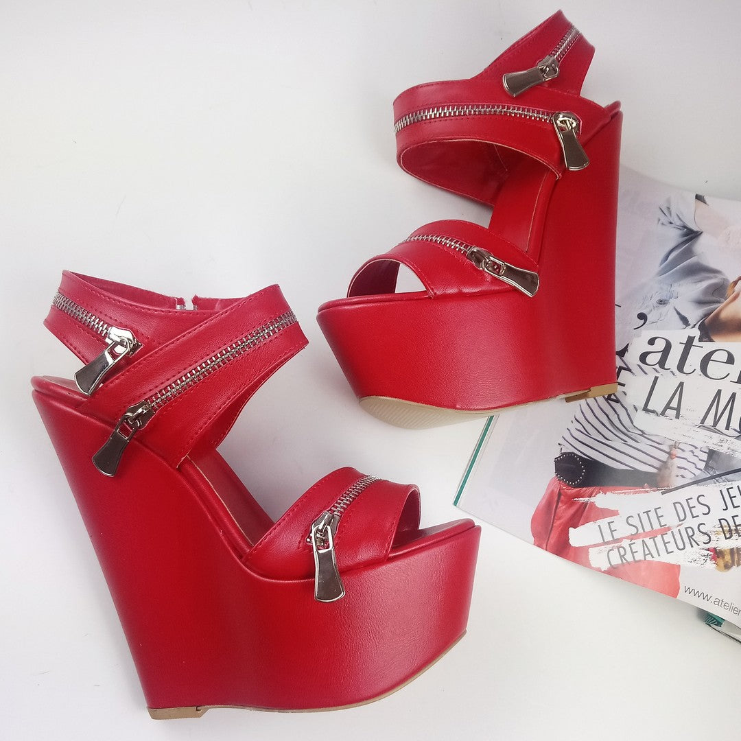 Red wedges sandals with zipper detail.