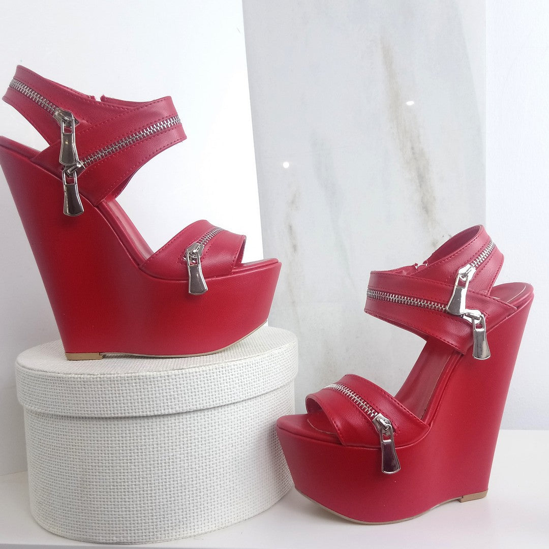 Red wedges sandals with zipper detail.