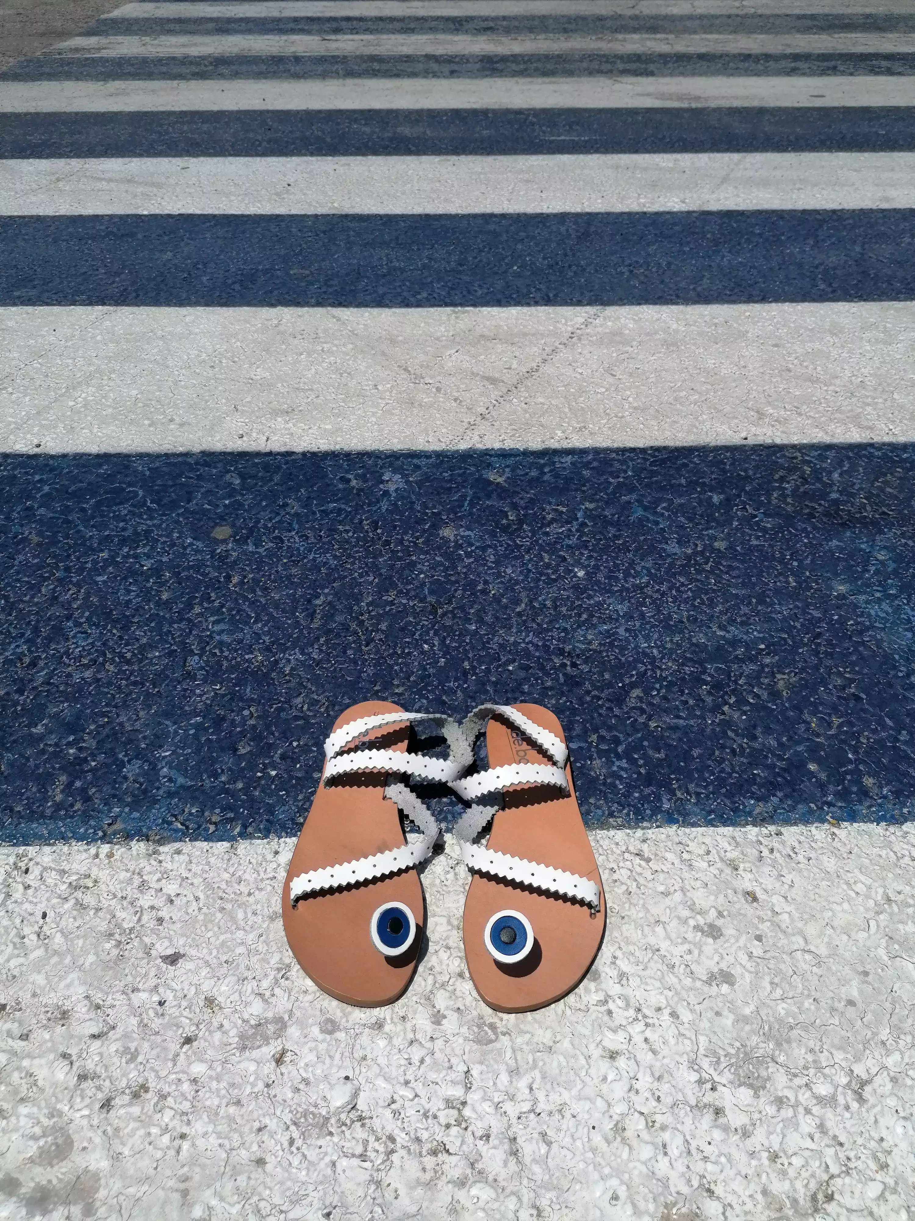 White flat leather sandals with evil-eye design